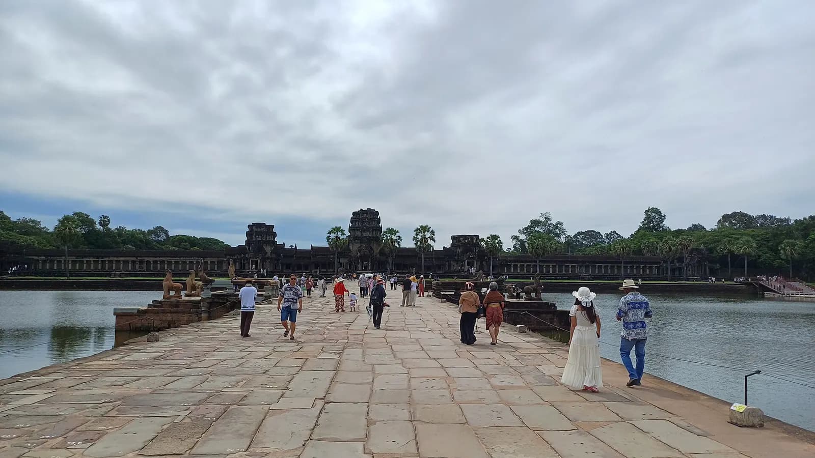 The stone causeway leading across the moat to Angkor Wat.